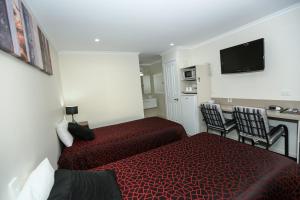 Postel nebo postele na pokoji v ubytování Amber Lodge Motel