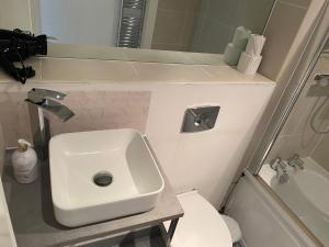 a small bathroom with a sink and a toilet at Stunning apartment in the heart of Leeds in Leeds