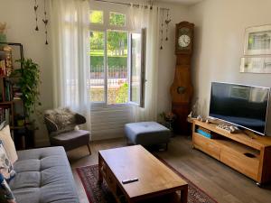 salon z kanapą i telewizorem w obiekcie Côté PECHEUR w mieście Honfleur