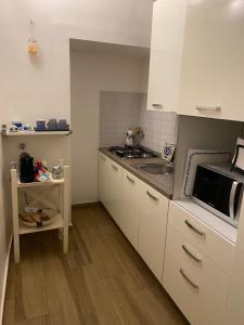 a small kitchen with a sink and a microwave at Guest house Novecento in Palo del Colle +15 photos