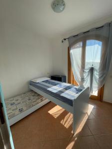 a bedroom with a bunk bed with a window at Casa delle Farfalle in Chia
