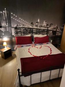 a bedroom with a bed with a heart on it at Guest house Novecento in Palo del Colle