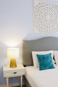 a bedroom with a bed with a lamp on a side table at Amélia - Always Algarve in Armação de Pêra
