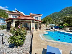 a house with a swimming pool in front of a house at Private Pool - Private 1000m2 Garden, 4 Bedroom - 3 Bathroom - 8 Person, DETACHED Villas, Unlimited WiFi - Free Parking in Fethiye