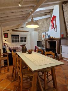 a dining room with a wooden table and chairs at El Atalanto in Madrigal de la Vera