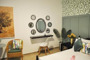 a bedroom with a bed and a mirror and a chair at Verde rete apartments2 in Áno Stavrós