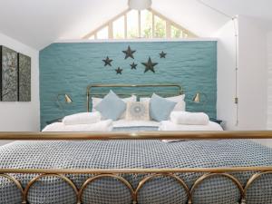 a bedroom with a bed with stars on the wall at Woodfield Coach House in Merrymeet
