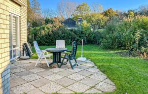a patio with a table and chairs in a yard at 3 Bedroom Stunning Home In Dirkshorn in Dirkshorn