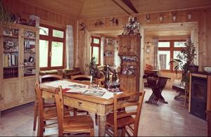 a dining room with a wooden table and chairs at Albergo Piani di Luzza in Forni Avoltri