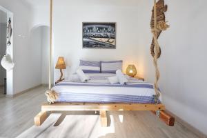 een bed in een kamer met een schommel bij Cozy Beach House São Pedro Estoril in São Pedro do Estoril