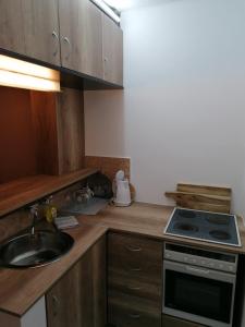 a kitchen with a sink and a stove at PIAR in Subotica +8 photos