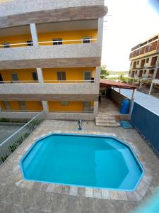 a swimming pool in front of a building at Condomínio manguezal, Apartamento 07 in Porto De Galinhas