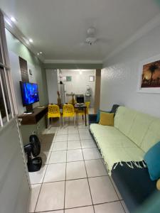 a living room with a couch and a table at Condomínio manguezal, Apartamento 07 in Porto De Galinhas