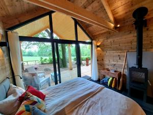 a bedroom with a bed in a room with a window at Forest Garden Romance 