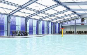 a large room with a pool of water with chairs at Stunning Home In Gramsbergen With Wifi in Gramsbergen