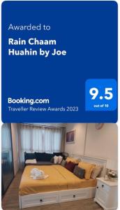 a picture of a bed in a bedroom with a blue background at Rain Chaam Huahin by Joe in Phetchaburi