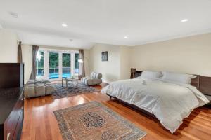 a bedroom with a large bed and a large window at The West Vancouver Getaway Estate - 5 Bedrooms in West Vancouver