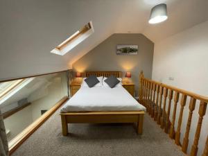 a bedroom with a bed in a room with a staircase at Embleton Spa Hotel & Apartments in Embleton
