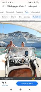 two men on a boat in the water at Appartamento Alla Marmora Porto Empedocle in Porto Empedocle