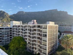 a view of a building with mountains in the background at Cape Breaks in Cape Town