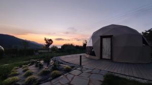 a large tent sitting on top of a patio at Luzada - Glamping Burbujas Galicia in Juances