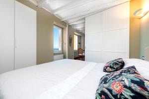 a bedroom with a white bed with a pillow on it at Mediterraneo Seaview Apartments in Rovinj