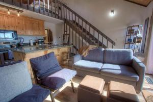 a living room with a couch and a chair and a kitchen at Bigler Bonus condo in Stateline