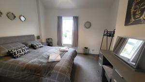 a bedroom with a large bed and a window at STAY - at Southport Holiday Home - sleeps 6 in Southport