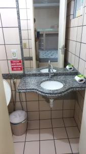 a bathroom with a sink and a toilet at diRoma Rio Quente - Para Voce se Sentir em Casa :D in Rio Quente