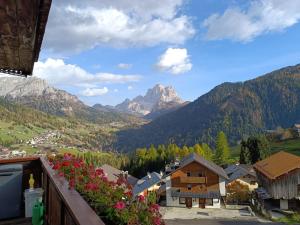 a view from a balcony of a village in the mountains at Dolomia in Villagrande