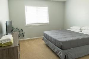 a bedroom with a large bed and a window at King Bed, TV's in Every Bedroom, Bring Your Pets! KMS1309 in Manhattan