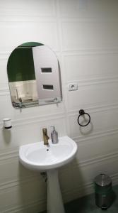 a bathroom with a white sink and a mirror at Borlova /Muntele Mic in Borlova +72 photos