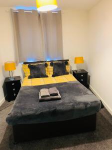 a bedroom with a large bed with two lamps on it at City Blessed Apartment 1 with free parking in North Shields