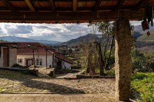 a view from the porch of a house with mountains in the background at Britelo 1828 - Refúgio na Natureza in Ponte da Barca
