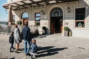 a family walking in front of a building at The St. Regis Florence in Florence