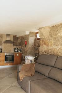a living room with a couch and a kitchen at Quinta do Rabelo in Braga