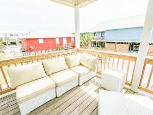 a porch with a couch on a deck at Duplex allows for one or both sides to be rented! Suitable for small or large families! in Gulf Shores