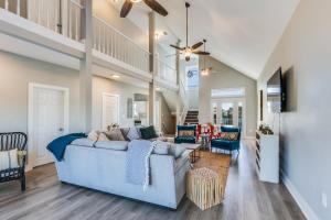 a living room with a blue couch and chairs at Modern, 3 BR Private House within Walking Distance to the Beach! in Gulf Shores