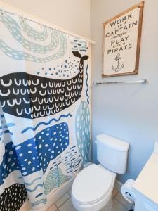 a bathroom with a toilet and a whale shower curtain at Modern, 3 BR Private House within Walking Distance to the Beach! in Gulf Shores