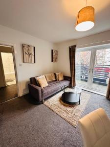 a living room with a couch and a large window at City Blessed Aptm 2 with free parking in North Shields