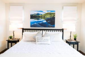 a bedroom with a white bed with two night stands at Close to RMNP, Estes,& Amenities in Estes Park