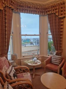 a living room with a large window at The Sands Hotel in Paignton