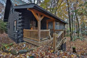 a log cabin with a porch and a deck at The Wells Cashiers in Cashiers