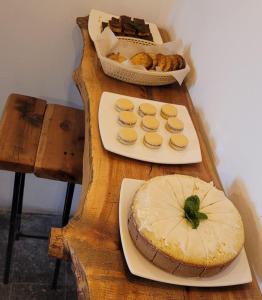 a table with two plates of food and a cake at Hostel Piltri in El Bolsón