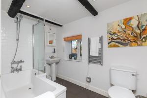a bathroom with a shower toilet and a sink at Barn Cottage -Westerlands in Graffham +102 photos