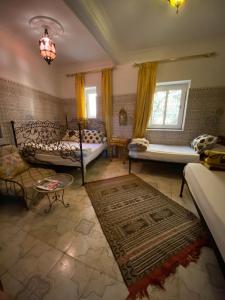 a living room with a bed and a couch at Fes Hostel Home in Fez