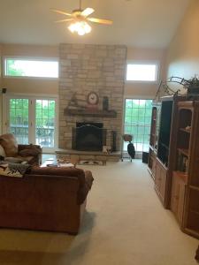 a living room with a couch and a fireplace at Highland Woods - Private home on 37 acres with stunning mountain views in Shaftsbury
