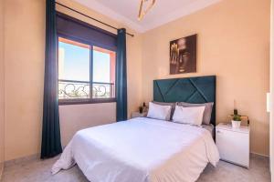 a bedroom with a large white bed and a window at Gueliz, Plaza, Zara in Marrakesh