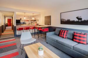 a living room with a couch and a table at Mountain Modern Motel in Jackson