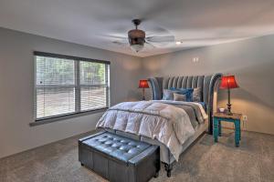 a bedroom with a bed and a ceiling fan at Le Bleu, Bright Hodgen Home with Fire Pit and Views! in Hodgen